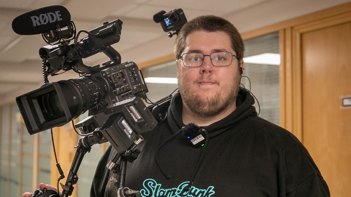 A picture of Film student Ben Bridges holding a camera
