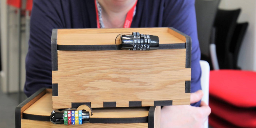 Light wooden box with black lock.