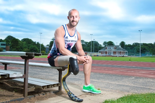 Gareth Dunn sat on side of running track.