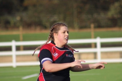 Megan Price playing rugby.