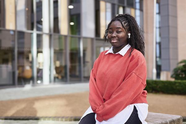 Business graduate sits outside Main Campus